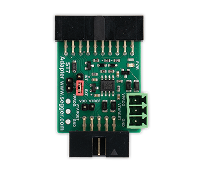ST7 Adapter Image of a green circuit board adapter with labeled pins and connectors, designed for interfacing electronic components. It includes components like resistors and capacitors, along with a red switch indicating the power settings. The adapter is identified as a "S7 Adapter" from Segger.