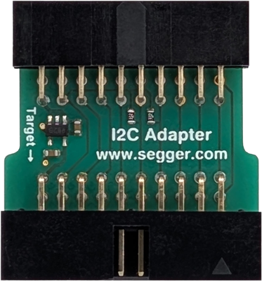 I2C Adapter The image shows an I2C adapter, a small green printed circuit board with pins for connections. It features a small chip and the text "I2C Adapter" along with the website "www.segger.com" printed on its surface. The left side indicates a target connection.